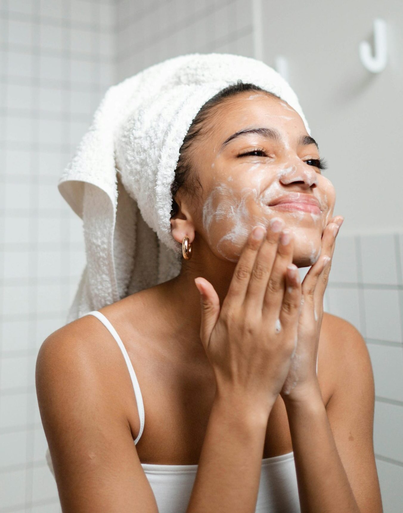 Black woman cleansing her face